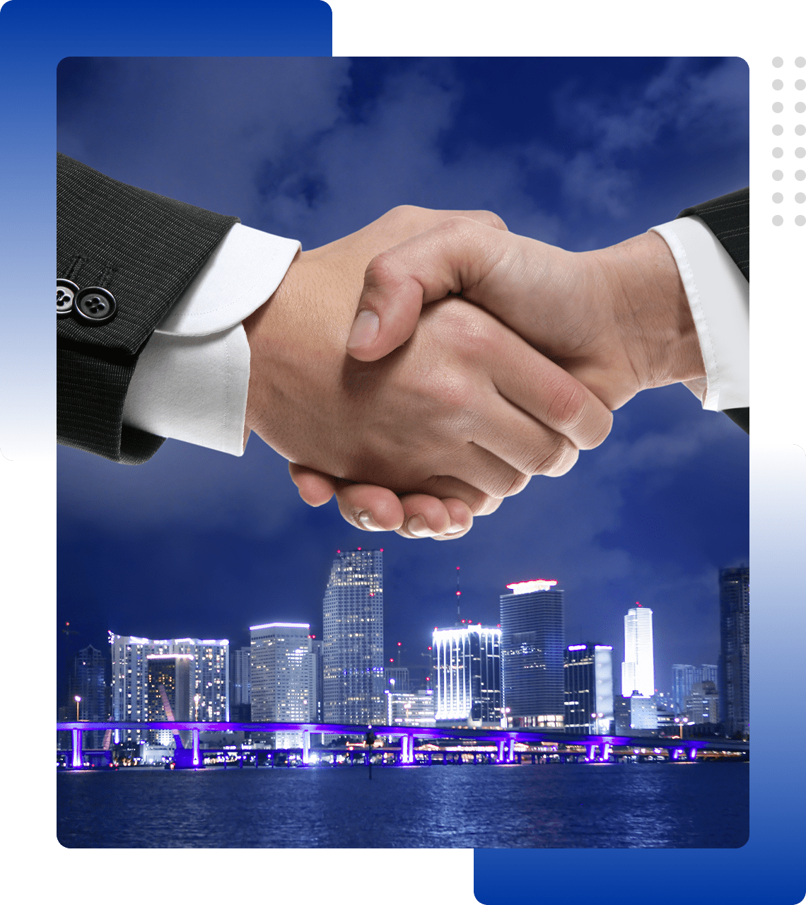 Business handshake with city skyline at night in the background.